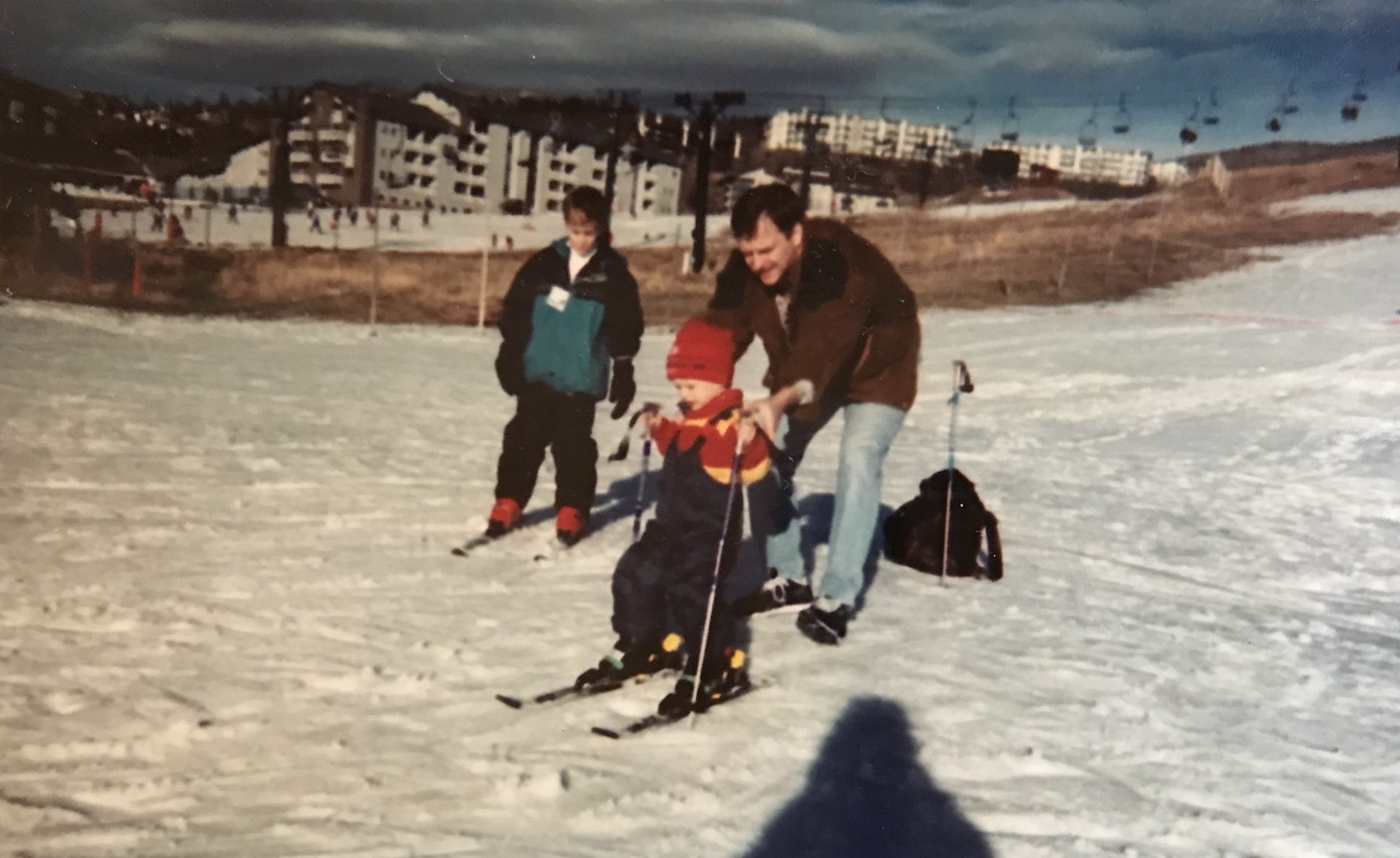 Picture of Nick, his brother, and his father skiing. 