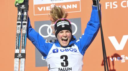 Jessica Diggins celebrates on the podium after finishing second in the FIS Cross Country World Cup 10k pursuit in Falun, Sweden. (Getty Images/AFP - Ulf Palm)